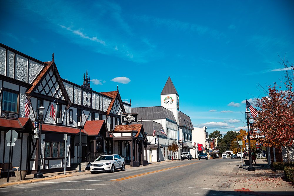 Downtown Batesville, Indiana, with Tudor-style storefronts on Main Street and the clock tower at the Sherman House.