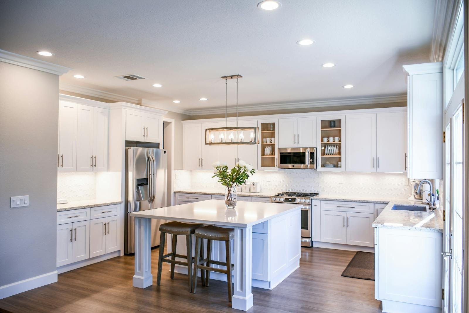 Newly finished white kitchen with stainless appliances after post-construction cleanup, drywall dust and fine particulate removed.